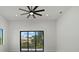 Bedroom features sliding glass doors that lead to an outdoor patio area and ceiling fan at 1605 Landfall Dr, Nokomis, FL 34275