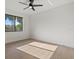 Bedroom features a ceiling fan and a window overlooking the exterior at 1605 Landfall Dr, Nokomis, FL 34275