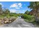 Community boat launch area by a serene pond with lush greenery and clear blue skies at 1605 Landfall Dr, Nokomis, FL 34275