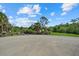 Community area featuring gravel parking area with views of a pond and natural landscape at 1605 Landfall Dr, Nokomis, FL 34275
