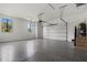 Spacious two-car garage with epoxy flooring, windows for natural light, and ample storage at 1605 Landfall Dr, Nokomis, FL 34275