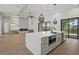 Open-concept kitchen with island, stainless appliances, fireplace, and sliding glass doors to a patio at 1605 Landfall Dr, Nokomis, FL 34275