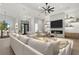 Bright, open living room with fireplace, modern fan, and stylish decor is ideal for entertaining and relaxing at 1605 Landfall Dr, Nokomis, FL 34275