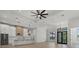 Open-concept room combining modern kitchen with stainless steel appliances, and dining area with modern lighting at 1605 Landfall Dr, Nokomis, FL 34275