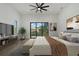 Spacious primary bedroom with large bed, modern decor, and sliding door access to a balcony at 1605 Landfall Dr, Nokomis, FL 34275