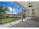 Covered patio with summer kitchen, stainless steel grill, granite counters, and outdoor fan at 1605 Landfall Dr, Nokomis, FL 34275