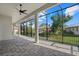 Screened-in patio offers a relaxing outdoor space with tiled flooring and views of the landscaped backyard at 1605 Landfall Dr, Nokomis, FL 34275