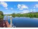 Scenic waterfront view from a wooden dock with a ladder for easy access to the water at 1605 Landfall Dr, Nokomis, FL 34275