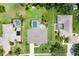 Expansive aerial view of a beautiful home with a screened pool, lush green lawn, and mature landscaping at 1711 145Th E St, Sarasota, FL 34212