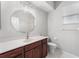Clean bathroom featuring a large round mirror, vanity with sink, and toilet at 1711 145Th E St, Sarasota, FL 34212