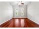 Bright bedroom featuring hardwood floors, a ceiling fan, and arched windows for natural light at 1711 145Th E St, Sarasota, FL 34212