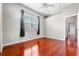 Bright bedroom with hardwood floors and a window with dark curtains at 1711 145Th E St, Sarasota, FL 34212