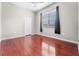 Cozy bedroom with hardwood floors, a ceiling fan, and a window with curtains at 1711 145Th E St, Sarasota, FL 34212