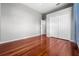 Bedroom featuring hardwood floors, a closet, and neutral walls at 1711 145Th E St, Sarasota, FL 34212