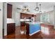 Modern kitchen with hardwood floors, white countertops, and stainless steel appliances at 1711 145Th E St, Sarasota, FL 34212
