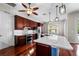 Modern kitchen features wood cabinets, stainless steel appliances, a center island, and stylish pendant lighting at 1711 145Th E St, Sarasota, FL 34212