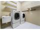 Convenient laundry room with a washer, dryer, sink, and shelving at 1711 145Th E St, Sarasota, FL 34212