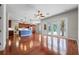 Open living space features hardwood floors, ceiling fan, kitchen view, and sliding glass doors to the outside at 1711 145Th E St, Sarasota, FL 34212