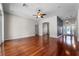 Hardwood floors, ceiling fan, and neutral paint colors in the living room give the home a bright feel at 1711 145Th E St, Sarasota, FL 34212
