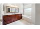Main bathroom features a double sink vanity, large mirror, and a soaking tub at 1711 145Th E St, Sarasota, FL 34212