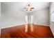 Hardwood floors, ceiling fan, neutral paint colors give the main bedroom a bright and comfortable feel at 1711 145Th E St, Sarasota, FL 34212
