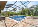 Screened-in pool area boasts a brick patio and ample sunlight at 1711 145Th E St, Sarasota, FL 34212