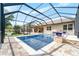 Relaxing screened pool area with brick patio, comfortable seating, and serene surroundings at 1711 145Th E St, Sarasota, FL 34212