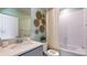 Bright bathroom with a single sink vanity, decorative wall art, and a shower-tub combination at 17904 Tavernside Trl, Bradenton, FL 34211