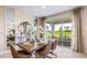 Bright dining room with access to a patio, featuring a modern table setting and elegant decor at 17904 Tavernside Trl, Bradenton, FL 34211