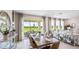 Elegant dining area with outdoor views, stylish furniture, and neutral decor at 17904 Tavernside Trl, Bradenton, FL 34211