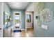Charming entryway with stylish decor, light blue walls, and tile flooring at 17904 Tavernside Trl, Bradenton, FL 34211
