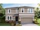 Beautiful two-story home featuring stone accents, neutral colors, and an attached two-car garage at 17904 Tavernside Trl, Bradenton, FL 34211