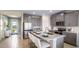 Modern kitchen featuring an island with seating, stainless steel appliances, and gray cabinetry at 17904 Tavernside Trl, Bradenton, FL 34211