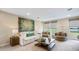 Cozy living room with neutral tones, comfortable seating, and natural light from the windows at 17904 Tavernside Trl, Bradenton, FL 34211