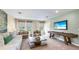 Inviting living room with shiplap accent wall, entertainment area, and comfortable furnishings at 17904 Tavernside Trl, Bradenton, FL 34211