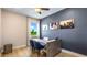 Home office showcasing a large window, modern light fixture, and custom wall art at 17904 Tavernside Trl, Bradenton, FL 34211