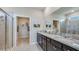 Bathroom features double vanity with granite countertop, walk-in shower, and walk-in closet at 18228 Beach Ranch Ter, Lakewood Ranch, FL 34211