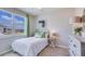 Bedroom with a large window and comfortable bed that allows plenty of natural light at 18228 Beach Ranch Ter, Lakewood Ranch, FL 34211