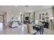 Open-concept living and dining area with stylish decor, large windows, and tile flooring at 18228 Beach Ranch Ter, Lakewood Ranch, FL 34211