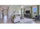 Bright living room features stylish furniture, large windows, and tile flooring at 18228 Beach Ranch Ter, Lakewood Ranch, FL 34211