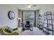 Home office featuring large window, ceiling fan, desk, and shelving unit at 18228 Beach Ranch Ter, Lakewood Ranch, FL 34211