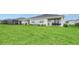 Expansive backyard featuring a covered patio, lush lawn, and a serene setting at 18324 Cropside Trl, Lakewood Ranch, FL 34211
