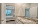 Elegant bathroom with double sinks, granite countertop, and view to primary bedroom at 18324 Cropside Trl, Lakewood Ranch, FL 34211