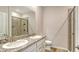 Bathroom featuring double sink vanity with granite countertop, a toilet, and glass enclosed shower at 18324 Cropside Trl, Lakewood Ranch, FL 34211