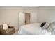 Comfortable bedroom featuring a cozy chair and view into the connected bathroom at 18324 Cropside Trl, Lakewood Ranch, FL 34211