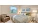 Comfortable bedroom featuring a cozy chair, and large window at 18324 Cropside Trl, Lakewood Ranch, FL 34211