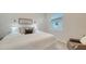 Bright bedroom featuring a large window, a comfortable bed, and modern decor at 18324 Cropside Trl, Lakewood Ranch, FL 34211