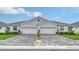 Charming home featuring a symmetrical elevation, paved driveway, and manicured landscaping at 18324 Cropside Trl, Lakewood Ranch, FL 34211
