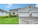 Charming home featuring a paved driveway, beautiful landscaping, and craftsman-style accents at 18324 Cropside Trl, Lakewood Ranch, FL 34211