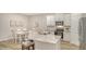 Open concept kitchen with white cabinets, granite countertops, and stainless steel appliances at 18324 Cropside Trl, Lakewood Ranch, FL 34211